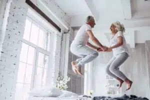 Fighting ageism older couple jump on bed