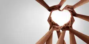 Diverse hands promoting a heart for unity to end racism