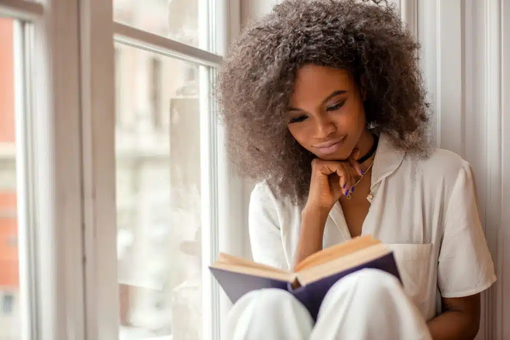 A pretty Black woman reads to transform her life