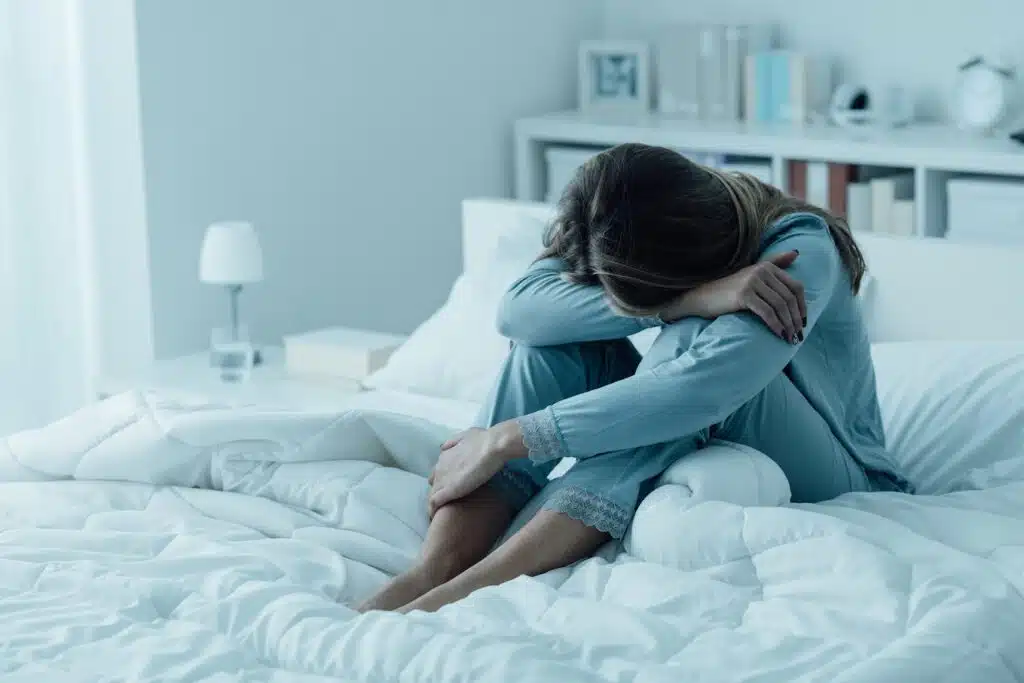 A woman suffering from insomnia, a symptom of low estrogen
