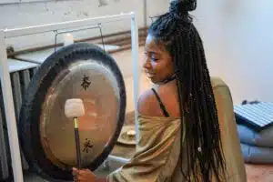 Brittany Simone Anderson on the gong performing sound healing