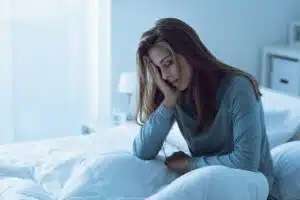 A woman struggles with insomnia due to sleep temperature