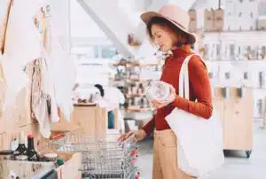 A woman in a hat shopping sustainably for the holidays