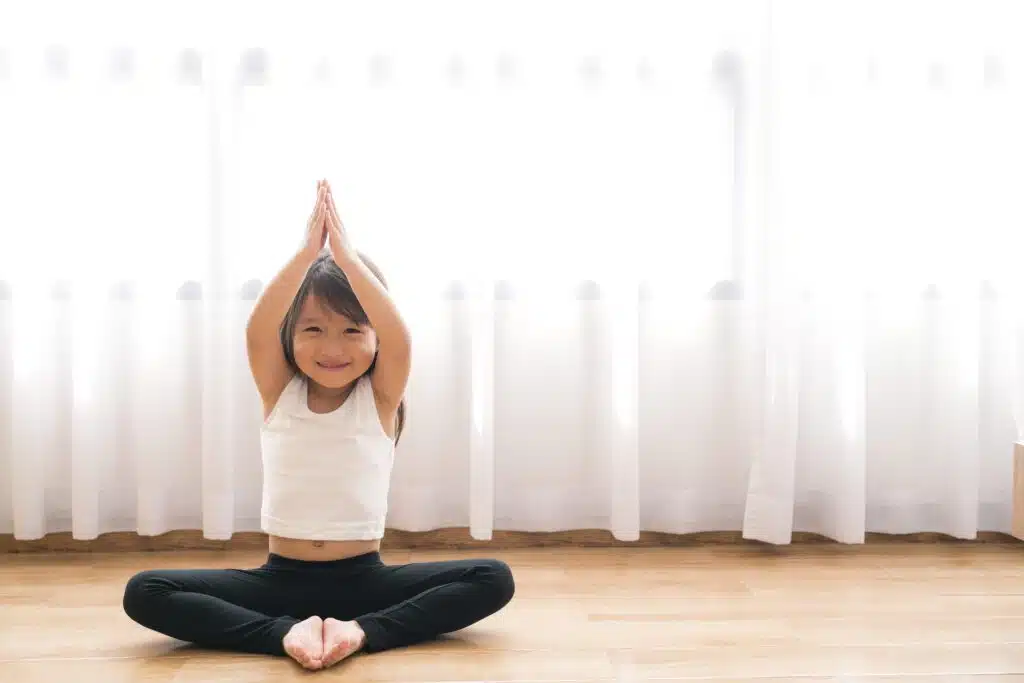 Asian girl doing kids' yoga