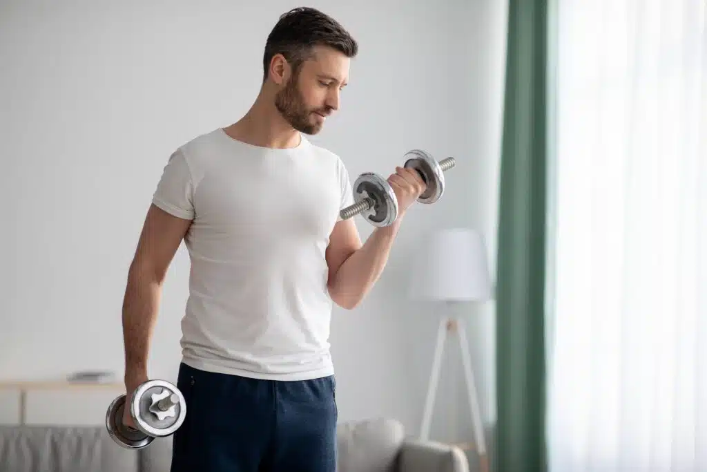 Man working out with weights to boost testosterone naturally