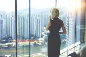 Back view of a woman looking out of a high-rise office