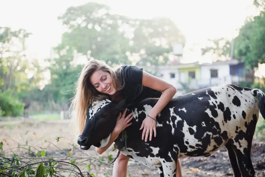 A woman hugs a cow