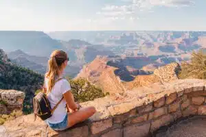 Woman sitting overlooking Grand Canyon National Park