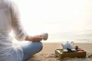 A woman enjoying tea on the beach