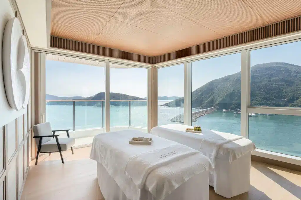 The Magnolia treatment room at The Fullerton Spa with floor-to-ceiling windows overlooking the sea
