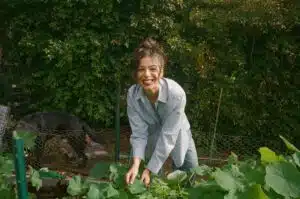 Olivia Amitrano, owner and CEO of Organic Olivia in a garden