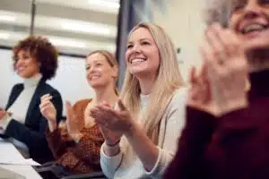 Women applauding at a conference