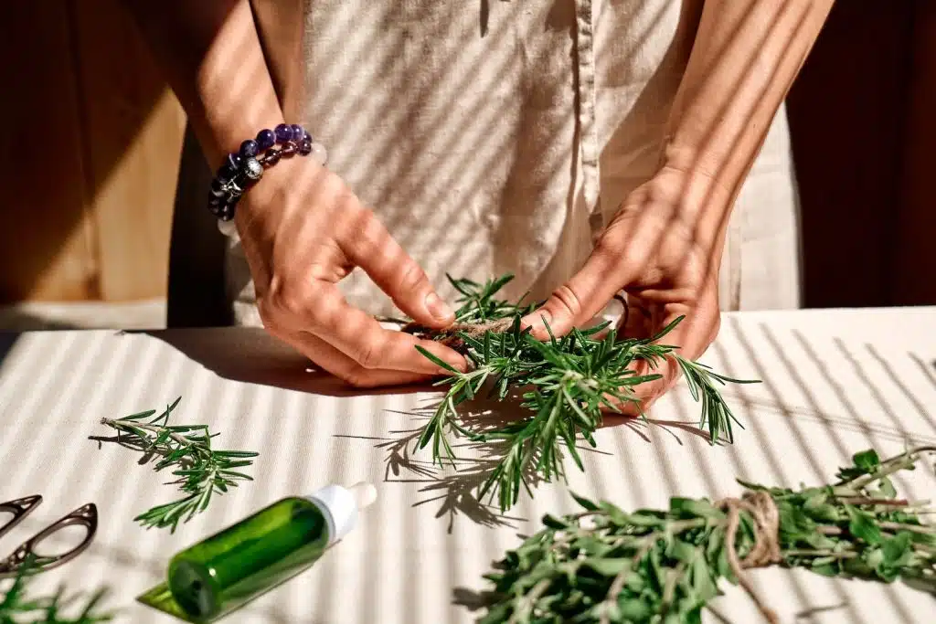 A woman's hands working with herbs
