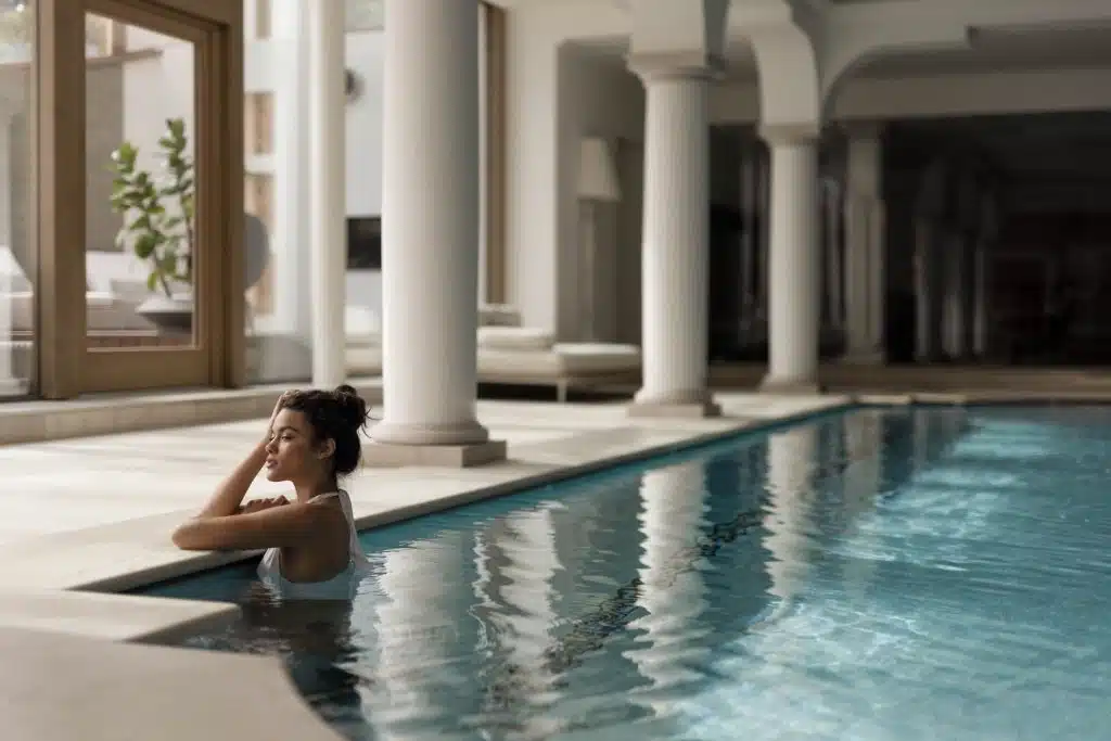 Grand Hotel Fasano spa pool with a woman gazing out the window from within the pool