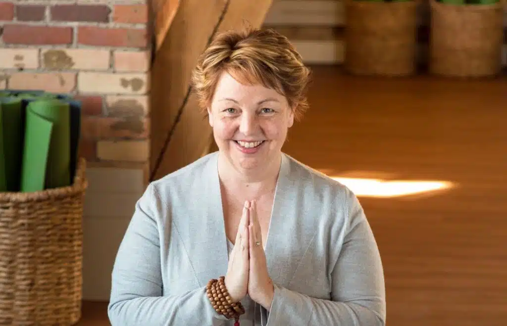 Laura Coburn with her hands in prayer