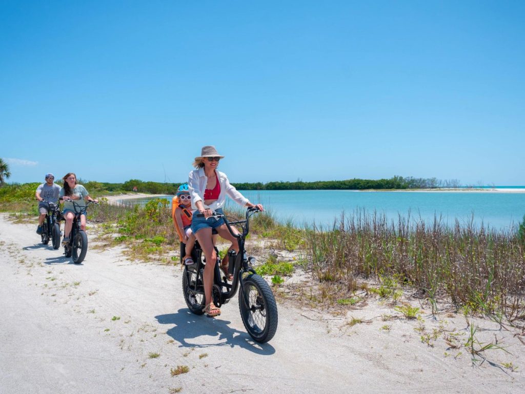 Family riding e-bikes near the coast in St. Pete-Clearwater